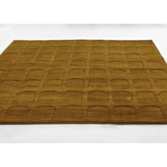 a brown area rug with squares and circles on the bottom, in front of a white background