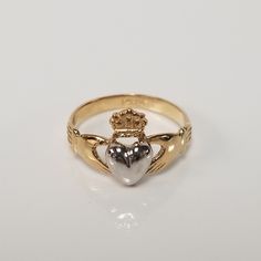 "Thanks for shopping our vintage estate store. We tend to sell well below wholesale and truly hope you enjoy all of our items. Many of the items are one of a kind, so please enjoy scrolling through the pictures and hopefully something will catch your eye. Blacks spots are from camera or reflections. Beautiful estate 14k gold yellow white gold Irish Claddagh infant or baby ring. Retails $299 on sale $149 Ring size: 1 Setting: 3/8\" 8.5mm Band width: 2mm Weight: .1.07 grams Beautiful ring, one tha Collectible 14k Gold Heart-shaped Jewelry, Classic Heart Jewelry For Collectibles, Heirloom Engraved Heart Ring, Classic Heart-shaped Collectible Jewelry, Classic Heart Shaped Collectible Jewelry, Classic 14k Heart-shaped Engraved Ring, Classic Heart-shaped Hallmarked Rings, Classic Polished Heart Ring For Anniversary, Classic Heart-shaped Engraved Ring Stamped 14k