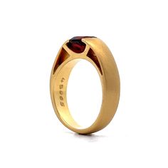 This versatile modern ring is perfect as the centerpiece of a stack or on its own. Crafted from 18 karat yellow gold, the ring features an oval cut garnet gemstone. The gemstone is flush set, with a weight of .95 carats. The brushed gold detailing adds a subtle texture and enhances the beauty of the garnet. Modern Yellow Gold Ruby Ring For Formal Occasions, Modern Yellow Gold Ruby Ring For Formal Events, Modern Ruby Ring For Formal Occasions, Modern Yellow Gold Ruby Ring With Polished Finish, Modern Garnet Rings For Anniversary, Contemporary Oval Rings For Formal Occasions, Modern Garnet Rings For Formal Occasions, Modern Garnet Rings For Formal Events, Modern Garnet Jewelry