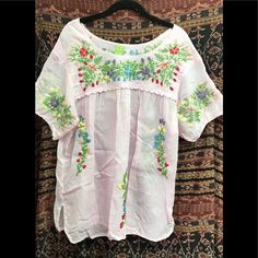 Cotton Short Sleeve Spring Bohemian Crew Neck Blouse, Casual Floral Embroidered Blouse For Vacation, Spring Crew Neck Blouse With Embroidered Hem, Casual Embroidered Spring Tunic Top, Summer Floral Embroidery Blouse For Daywear, Spring Bohemian Blouse With Embroidered Hem, Peasant Style Embroidered Top For Vacation, Spring Beach Peasant Style Embroidered Top, Summer Blouse With Floral Embroidery For Daywear