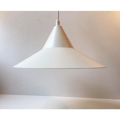 a large white light hanging from a ceiling