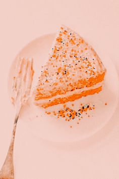 a piece of cake sitting on top of a white plate with a fork next to it