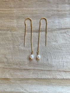 "These long threader earrings are a beautiful combination of petite pearls and gold filled dainty chain.  Enjoy giving these earrings as a gift, for a wedding or pairing them with your favorite new outfit! -2 3/8\" Freshwater pearl dangles  -White Freshwater rice round pearls (4-5mm) -Gold Filled Dainty Box Chain Threader Ear wire  ---These are perfect for brides and bridesmaids! Bulk order available upon request! 💗 Gold Minimalist Dainty Pearl Threader Earring | Simple Pearl Bridal Earring | L Everyday White Pearl Drop Threader Earrings, Dainty Pearl Charm Dangle Threader Earrings, Dainty Dangle Threader Earrings With Pearl Charm, White Pearl Drop Threader Earrings, Dainty Adjustable Threader Earrings With Pearl Drop, White Dainty Pearl Drop Threader Earrings, White Dainty Threader Earrings With Pearl Drop, Delicate Pearl Charm Threader Earrings Gift, Dainty White Pearl Drop Threader Earrings