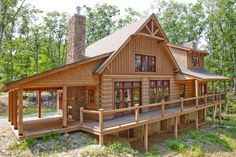 a log cabin with porch and wrap around deck