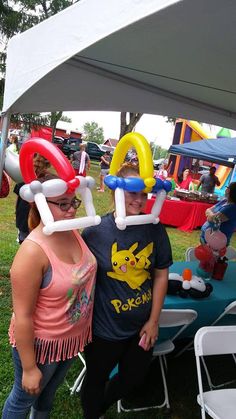 two women standing under an inflatable structure