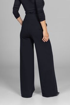 Why we love this: Step into the epitome of grace with our Black Grace Wide Leg Pant. These must-have black dress pants are designed for any occasion. With a super-flattering waist & roomy pockets, you’ll be dashing from desk-to-dinner with ease. Features: KiraGrace PowerStrong: Feels like cotton, keeps you dry High-rise, 32" inseam, Leg Opening: 25" Slimming high waist w/side pockets Made in U.S.A. of imported fabric Waist: High-Waisted (13" Rise) Inseam: 32" inseam, easy to hem For easy alterations - click here Leg Shape: Straight wide leg Sizing: Relaxed fit, size down if in between sizes Compression: Flowy- No compression Model, Kori, is 5'10" and wearing a size small Modern Black Pants For Office, Modern Black Office Pants, Black Wide-leg Pantsuit For Fall, Black Business Casual Pantsuit With Pockets, Black Business Casual Pantsuit With Straight Pants, Black Pantsuit With Straight Pants For Business Casual, Black Straight Pantsuit For Business Casual, Tailored Black Wide Leg Pants For Business Casual, Black Tailored Wide-leg Pantsuit