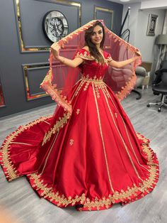 a woman in a red and gold ball gown