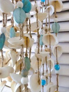 shells and seashells hanging from a window