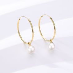 Unveil your elegance with our Freshwater Pearl Drop Large Hoop Earrings. Carefully constructed gold vermemil on Sterling Silver, these hoops offer a harmonious blend of contemporary grace and timeless appeal. The attached freshwater pearl renders a classic touch, creating a versatile piece that suits both everyday elegance and sophisticated soirées. Immerse yourself in the delicate charm and modern luxury of this exquisite pair. Pearls size: 8-9mm 14k Yellow Gold Filled Round Pearl Earrings, Small Hoop Pearl Earrings In Yellow Gold, Small Hoop Yellow Gold Pearl Earrings, Classic Gold Hoop Earrings With Pearl Charm, Classic Gold Hoop Pearl Earrings, Yellow Gold Pearl Small Hoop Earrings, Gold-plated Hoop Earrings With Pearl Drop For Anniversary, Classic Gold Plated Hoop Earrings With Pearl Drop, Classic Gold-plated Hoop Earrings With Pearl Drop