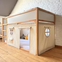 a bunk bed with curtains on the top and bottom is made out of white canvas