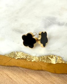 Add a touch of elegance and playfulness to your outfit with our Gold Clover Earrings. Made of 18k gold plated stainless steel, these earrings will dazzle and dance in the light, making your earlobes the star of the show! Perfect for both daytime adventures and nighttime escapades. How about you indulge in the luxurious choice of either black or white pearl? Or why not both?😍 Features: 18k Gold Plated High-Quality Stainless Steel Tarnish Free Modern Gold Plated Plug Earrings For Gift, Modern Gold Plated Plug Earrings As Gift, Trendy Gold Flower-shaped Jewelry, Modern Gold-plated Plug Earrings As Gift, Yellow Gold Stainless Steel Earrings For Gift, Gold Drop Earrings With Black Enamel, Gold Black Enamel Drop Earrings, Black Gold-plated Earrings For Gift, Trendy Hypoallergenic Gold Flower Earrings