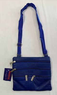 Marshal Wallet Brand Genuine Leather Blue Purse Crossbody. Condition is new with tags. There is a slight stitching defect on the back just above the zipper; see pics. Shipped with USPS first class. Colors vibrant, item free from stains or damage unless noted above. Measurements are in inches laying flat. See pics. - Our items are all carefully examined, measured, photographed and stored in a smoke free/Pet friendly environment. Shipping: I am not responsible for undeliverable addresses. For My I Blue Wallets With Zipper Closure For Daily Use, Blue Wallet With Zipper Closure For Daily Use, Blue Travel Wallet With Zipper Pocket, Blue Wallet With Zipper Pocket For Daily Use, Blue Rectangular Wallet With Zipper Pocket, Blue Wallets With Zipper Pocket For Everyday Use, Blue Crossbody Wallet With Cell Phone Pocket, Blue Leather Wallets With Cell Phone Pocket, Blue Leather Wallet With Cell Phone Pocket