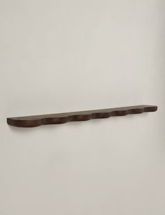 a long wooden shelf on the wall