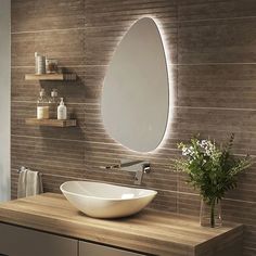 a bathroom sink sitting under a mirror next to a shelf with a vase on it