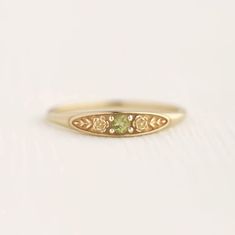 August birth ring This ring will be a very meaningful piece for those born in August . August's birthstone and birth flower are Peridot and Poppy. Greeny peridot and delicately carved poppy will shine and bloom forever. This dainty and slim signet ring is comfortable to wear all the time. This piece will be perfect gift for both to others and yourself. * Detail * Material : 14K solid gold, 18K solid gold, 925 sterling silver Color : Yellow gold, White gold or Rose gold(925 sterling silver is excluded) Stone : Natural Peridot(2.5mm) * Size * Top width : 3.7mm Shank width : 1.2mm Band depth : 2.4-0.9mm * Please check your ring size before ordering, Use this : http://www.onlineconversion.com/ring_size.htm We provide special package with some our business card, guarantee card, gift box. Please Green Birthstone Signet Ring Gift, Yellow Gold Flower Promise Ring For May Birthstone, Green Engraved Ring As Gift, Green Engraved Ring As A Gift, Heirloom Peridot Ring As Gift, Heirloom Peridot Ring Gift, Heirloom Peridot Ring For Gift, Birth Ring, Poppy Ring