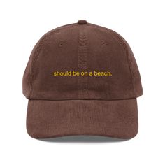 Should be on a beach, and most certainly NOT here. • 100% cotton corduroy • Unstructured, 6-panel, low-profile • Cotton twill sweatband and taping • 6 embroidered eyelets • Adjustable strap with a gold-colored metal buckle • Head circumference: 20″–22″ (50.8 cm–56 cm)Polychrome Goods 🍊 Original Designs ☆ 100% Cotton Twill ☆ Adjustable Strap with Metal Clasp ☆ One Size Fits All Embroidered Hat, Navy And Brown, Embroidered Hats, Vintage Candles, Saved Items, Head Circumference, Metal Buckles, Black And Navy, One Size Fits All