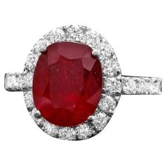 Luxury Red Ruby Gemstone Ring, Classic Red Jewelry With Halo Design, Luxury Red Ruby Ring With Center Stone, Classic Red Halo Ring With Center Stone, Luxury Red Oval Rings, Classic Red Diamond Ring With Halo Setting, Gia Certified Red Ruby Ring, Gia Certified Fine Jewelry Red Ruby Ring, Red Ruby Round Ring, Luxury