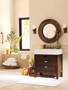 a bathroom with a mirror and sink on the wall next to an open window, which reads pottery barn search back to products bark - wrapped mirror $ 699 99