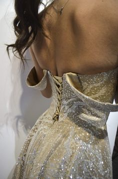 the back of a woman's dress with sequins on it