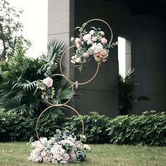 a tall metal sculpture with flowers on it