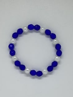 Material: Clear String Color: Royal Blue and White Type: Bracelet Style: Glamorous Elegant Sapphire Bracelets With Faceted Beads, Elegant Sapphire Bracelet With Faceted Beads, Adjustable Faceted Sapphire Bracelets, Adjustable Faceted Sapphire Bracelet, Elegant Adjustable Blue Crystal Bracelet, Party Blue Crystal Bracelets, Elegant Blue Stretch Bracelet With Faceted Beads, Blue Faceted Beads Bracelet, Elegant Blue Faceted Bracelets