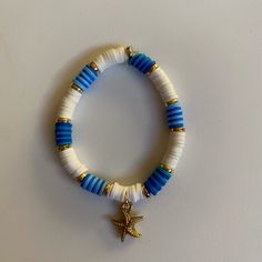 Blue & white themed starfish charm bracelet Adjustable Blue Jewelry With Starfish Charm, Adjustable Blue Starfish Jewelry, Adjustable Blue Bracelets With Starfish Charm, Blue Star Jewelry For Vacation, Blue Star Shaped Jewelry For Vacation, Blue Bracelets With Starfish Charm Ocean-inspired, Blue Star Charm Bracelet, White Star-shaped Jewelry With Starfish Charm, Blue Beaded Bracelet With Starfish Charm