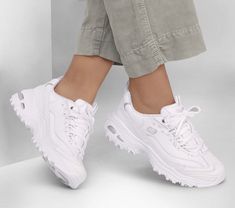 Put your best foot forward in a revitalized classic look with Skechers D'Lites - Fresh Start. This sporty lace-up style features a smooth leather and synthetic upper with a cushioned Air-Cooled Memory Foam insole. | Skechers Women's D'Lites - Fresh Start Sneaker | Medium Width | Skechers Air-Cooled Memory Foam cushioned comfort insole | Smooth leather and synthetic upper | Sporty lace-up fashion sneaker design | Lightweight shock-absorbing supportive midsole | Flexible rubber traction outsole | Sketchers Shoes For Women, Trendy White Shoes, White Sketchers Sneakers, Sketchers Dlites, White Skechers, Skechers Shoes Women, White Skechers Dlites, Sketchers Shoes, Skechers D Lites