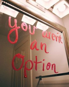 a sign that says you aren't an option on the side of a mirror