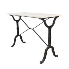 a white table with black legs and a marble top