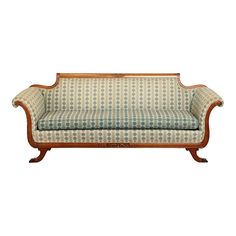 an old fashioned couch with wooden frame and fabric upholstered on the back end