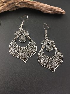 Indus Earrings : Back to our Roots. For the women who makes a statement.  An exclusive shop for earrings. Wear them with pride.  These are dangling drops style earrings . An unique handmade Indian style ethnic bohemian/ Tribal earrings in silver shade.  These earrings are made from high quality Tatanium / German silver material  which are hypoallergenic and free from corrosion & rusting.  Notes : The product shipped will be same as shown in the picture, however the actual colours may vary slightly due to the natural lighting in the photography. We do not accept returns or refunds , however in case of any issues we will definitely try and resolve it. Bohemian Metal Plug Earrings For Pierced Ears, Bohemian Metal Plug Earrings With Ear Wire, Traditional Dangle Teardrop Earrings, Bohemian Silver Teardrop Earrings, Bohemian Metal Chandelier Earrings With Ear Wire, Ornate Chandelier Earrings With Ear Wire, Traditional Teardrop Dangle Earrings, Bohemian Metal Chandelier Earrings Nickel Free, Teardrop Chandelier Earrings For Festival