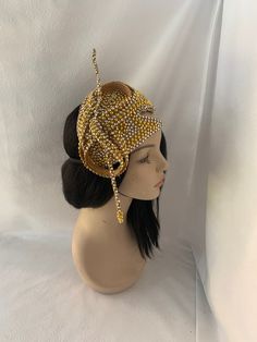 Absolutely beautiful! This is an elegant unique design gold OOAK (one of a kind) vintage 1960 styled pearl beaded with rhinestone jeweled half hat fascinator perfect for weddings, Mother of the Bride hat, Bridal fascinator hat, Church hats, COGIC women convention hats, tea parties and special occasion headpiece. Looking for a unique handmade fashion lover gift for women, then this is a perfect gift.  E A S Y  T O  W E A R  Forms to the contour of your head.  Light weight  Unique design Different ways to wear Ready to wear   elastic attachment to hold comfy  Gold  pearl with rhinestone trim covered on a lightweight millinery base and a satin underneath to protect hair. S H I P P I N G : Expedited shipping upgrades are available at check out. We use Our local postal service to reflect a more Gold Pinched Crown Hat For Evening, Luxury Gold Hat For Evening, Adjustable Gold Hat Headpiece, Luxury Vintage Hat Headpieces, Luxury Cream-colored Hat Headpiece, Mother Of The Bride Hats, Bridal Fascinator, Bride Hat, Rhinestone Trim