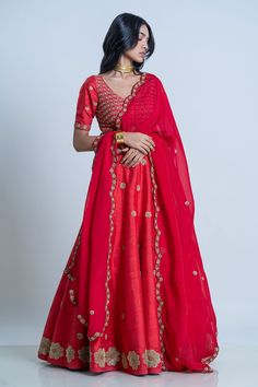 Red raw silk floral embroidered lehenga with attached cancan. Paired with wide V-neck padded blouse and dupatta.
Component: 3
Pattern: Embroidery
Type Of Work: Floral
Neckline: Wide V
Sleeve Type: Half
Fabric: Blouse and Lehenga: Raw Silk; Dupatta: Organza
Color: Red
Other Details: 
Lehenga Length: 42 inches
Scallop embroidered border dupatta
Tassel tie-up detailing
Note: The neckpiece worn by the model is not for sale
Occasion: Bride,Wedding - Aza Fashions Red Floral Blouse, Organza Embroidery, Padded Blouse, Embroidered Lehenga, Embroidered Border, Pantsuits For Women, Red Blouse, Pattern Embroidery, Silk Dupatta