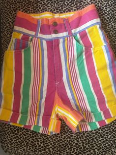 Vintage 1990's High Waisted Denim Shorts Vertical stripes  Yellow, white, pink, orange, purple, green, blue Zip and snap waist closure Great vintage condition- light wear, no flaws to note Measurements (in inches): Waist: 26 Length: 16 Hip: 35 Colorful High-waist Bottoms For Spring, High Waist Colorful Bottoms For Spring, High-waisted Colorful Bottoms For Spring, Multicolor High-rise Bottoms With Pockets, Trendy Multicolor High Rise Bottoms, Multicolor High Rise Bottoms With Pockets, Trendy High Rise Multicolor Bottoms, High Rise Multicolor Cotton Bottoms, Colorful Fitted Bottoms For Summer