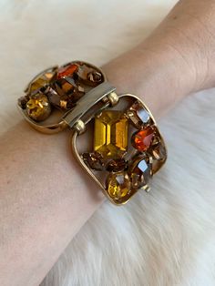 "Vintage 1940's statement signed Napier bracelet. Gold tone bracelet with amber, brown, and bright orange rhinestone crystals. Rhinestones are oval, circle, baguette, emerald, and tear drop cut. Bracelet in excellent condition with minor wear due to age. High quality and high shine rhinestones. Measurements Length: 6-3/4\" / Width: 1-1/2\" / Unless otherwise stated all vintage items are used and may have minor to moderate wear or discoloration considering the age of the item. Most items have bee Mid-century Handmade Formal Jewelry, Vintage Amber Rectangular Jewelry, Brown Rectangular Metal Jewelry, Rectangular Brown Metal Jewelry, Vintage Jeweled Jewelry For Evening, Mid-century Metal Bracelet Jewelry, Vintage Orange Metal Jewelry, Collectible Vintage Amber Jewelry, Unique Formal Jewelry