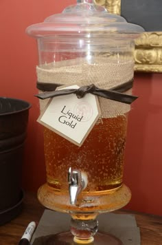 a glass filled with liquid sitting on top of a wooden table