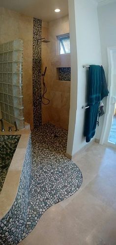 a bathroom with a large walk in shower next to a sink