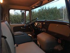 the interior of an old truck with leather seats