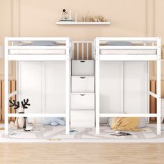 two white bunk beds sitting next to each other on top of a hard wood floor