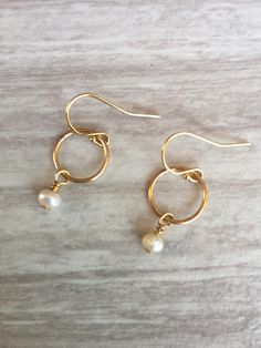 Pearl Circle Earrings. These beautiful small hoop earrings feature a single 4-5 mm freshwater pearl wire wrapped onto a gold-filled hoop. The hoop is approximately 6 mm. The hoops and French wires are gold filled. Pearl is the June birthstone. Your earrings will arrive in a gift box. If this is a gift, I would be happy to include a card with your personal message - just let me know in the message section at checkout. Diy Earrings Pearl, Pearl Earrings Gold, Small Dangle Earrings, Pearl Dangle Earrings, Earrings Bridesmaid, Jewelry Design Earrings, Earrings Inspiration, Myrtle Beach Sc, Earrings Pearl