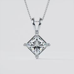 Dazzle her with the shimmering radiance of this magnificent princess cut solitaire pendant.  Exquisitely made according to your selection of precious metal, this magnificent solitaire pendant comes with a 16"-18" Adjustable Diamond Cut Cable Chain included, and can be customized to your exact specifications to accommodate a Simulated Diamond up to 5 carats in size. The base price includes a 1.0CT Solitaire.  Please select your choice of Precious Metal, Stone Size and Chain preference from the dr Princess Cut Diamond Necklace For Gift, Anniversary Solitaire Square Pendant Necklace With Prong Setting, Diamond Princess Cut Solitaire Necklace In Fine Jewelry Style, Princess Cut Diamond Necklace In Fine Jewelry Style, Diamond White Square Pendant Solitaire Necklace For Anniversary, Fine Jewelry Solitaire Square Pendant Necklace For Anniversary, Princess Cut Diamond Necklace With Diamond Cut, White Gold Diamond Necklace With Princess Cut, Square Pendant Solitaire Necklace With Diamond Accents