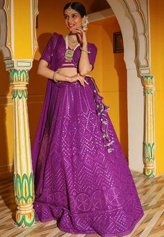 Readymade Faux Georgette Lehenga in Purple. This attire with Cotton and Shantoon Lining is Enhanced with Fancy Dangles, Resham, Mirror and Sequins Work. Available with a Faux Georgette Purple Choli Crafted in V Neck and Half Sleeves and a Faux Georgette Dupatta in Purple. The Choli and Lehenga Lengths are 15 and 42 inches respectively. We sell all kinds of Lehenga and Chaniya Choli Casual Lehenga |Sangeet Lehenga Choli |Wedding Lehenga Choli |Haldi Lehenga Choli |Mehandi Lehenga Choli |Chaniya C Purple Sequined Lehenga For Eid, Embellished Purple Georgette Set, Purple Embellished Georgette Sets, Fitted Purple Sequined Choli, Purple Sequined Fitted Choli, Purple Sequined Lehenga For Navratri, Purple Sequined Dupatta For Navratri, Purple Sequined Traditional Wear For Diwali, Purple Sequined Sets For Navratri