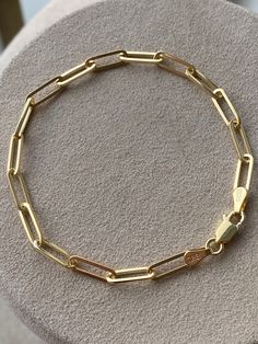 Statement piece for your wrist stack. Features oval-shaped elongated paper link design. Handcrafted in 14K Gold. This beauty is perfect for layering! Makes the perfect gift that will last a life time! 7 inches Solid 14K Gold. 5.5 grams. All our items have been fully inspected for authenticity and condition by a GIA Graduate Gemologist. To see more carefully selected Vintage Bracelets and Watches from Gold Adore, please visit: https://www.etsy.com/shop/GoldAdore?section_id=10797490&ref=shopse Modern Oval Paperclip Bracelet As Gift, Modern Oval Paperclip Bracelet For Gift, Everyday Gold Oval Bracelet With Cable Chain, Oval Cable Chain Bracelet For Everyday, Everyday Oval Cable Chain Bracelet, Luxury Oval Link Paperclip Bracelet Gift, Classic Oval Paperclip Bracelet For Gift, Minimalist Oval Chain Bracelet With Solid Links, Everyday Yellow Gold Oval Paperclip Bracelet