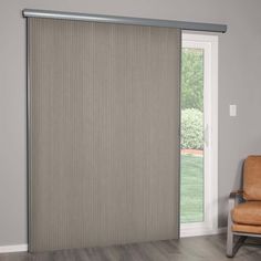 a living room with a sliding glass door that has blinds on the outside and inside