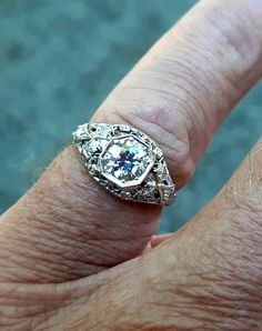 A wonderful Victorian band with great filigree detail. The center stone measures out at .80 ct and has a clarity of SI1 and G color. There is a small natural crystal on the girdle. On either side are 2 @.05ct diamonds set in diamond shape gold. The band weighs 2.5 grams and is is excellent condition. It measures 8.5mm across the top. Anniversary Jewelry With Asscher Brilliant Cut, Brilliant Asscher Cut Jewelry For Anniversary, Antique Brilliant Cut Diamond White Ring, Antique Brilliant Cut Diamond White Diamond Ring, Antique Diamond White Diamond Ring With Brilliant Cut, Vintage Diamond Jewelry With Intricate Design, Antique Diamond White Diamond Ring, Antique Jewelry In Diamond White With Brilliant Cut, Classic Jewelry With Single Cut Round Diamonds