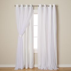 a white curtain hanging on the side of a window in front of a wooden floor