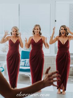 a woman in a red dress is looking at her reflection in the mirror and laughing