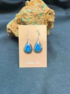 Beautiful Blue Opal handcrafted onto sterling silver inlay in the shape of a tear drop. Small and quaint earring that is beautiful in person. These earrings are unique and stunning in person, a southwestern style classic. Earring Length Including Ear Wire: 1.25 Inches Earring Length without Ear Wire: .75 Inches Earring Width: .5 Inches Light and Delicate - but perfect for every day wear! This item ships in a Gift Box! Same Day Shipping! Artisan Sterling Silver Teardrop Dangle Earrings, Artisan Sterling Silver Nickel-free Teardrop Earrings, Artisan Teardrop Nickel-free Earrings, Artisan Teardrop Nickel Free Earrings, Sterling Silver Teardrop Pendant For Pierced Ears, Artisan Teardrop-shaped Sterling Silver Jewelry, Artisan Teardrop Jewelry Stamped 925, Silver Southwestern Style Teardrop Dangle Earrings, Southwestern Silver Dangle Teardrop Earrings