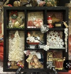 a display case filled with lots of christmas decorations and ornaments on top of a table