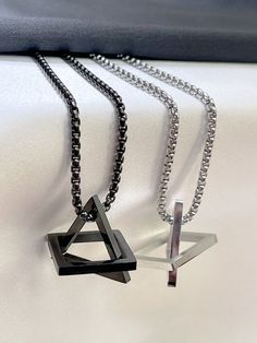 Interlocking Triangle Square Pendant Necklace, Geometric Stacking, Silver, black interlock necklace, triangle necklace~ Materials :  silver and black  (stainless steel chain)~ Style :  necklace~ Length : can make a specific length if you want.~ Can also be made to a bracelet pls message if you want a braceletThe necklace we have 18, 20, 22 , 24, 26 or 30 inches. Please pick a size.We have 2 pendant sizes 4 cm and 4.5 cm please let us know which one you would like ALL SHIPPING COMES WITH TRACKING Black Geometric Jewelry, Black Stainless Steel Clavicle Chain Necklace, Geometric Black Jewelry For Gifts, Minimalist Triangle Metal Necklace, Minimalist Geometric Metal Necklace, Black Stainless Steel Chain Necklace, Modern Geometric Metal Necklace, Modern Black Geometric Necklace, Modern Black Stainless Steel Chain Necklace